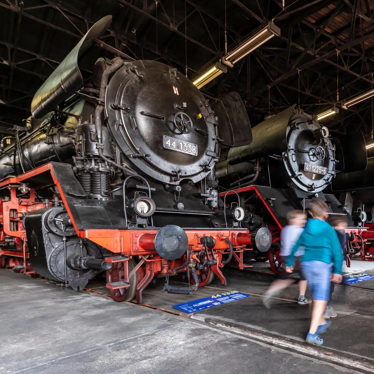 Freigelände mit Gleisen, Signalbrücken und zwei Besucherinnen