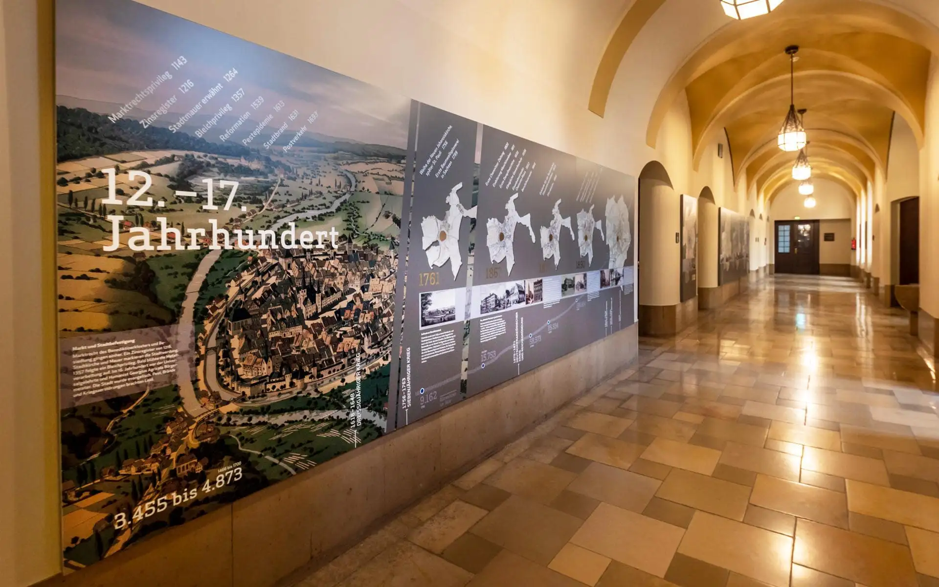 Große historische Wandgrafik im Rathaus Chemnitz mit Stadtgeschichte und Karten.