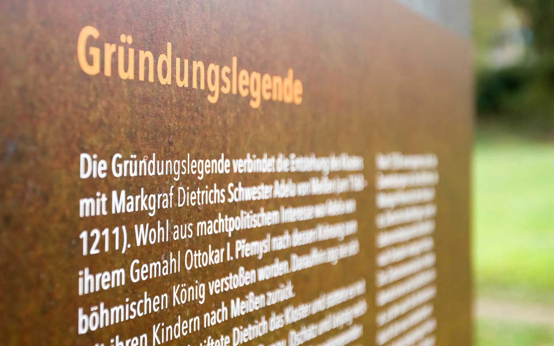 Nahaufnahme der Infotafel zur Gründungslegende an der Heilig-Kreuz-Ruine mit hervorgehobener Überschrift.